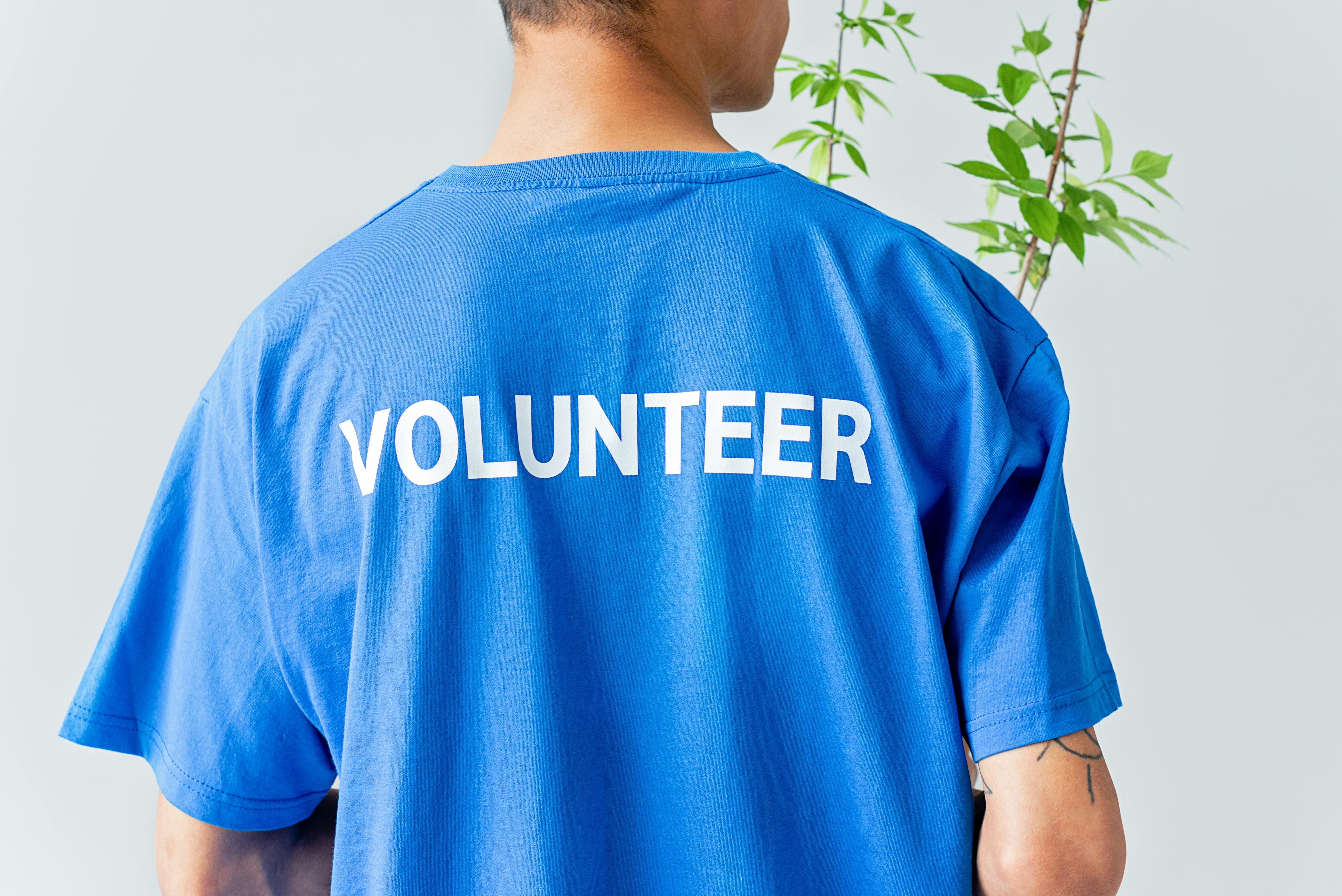 A group of diverse volunteers working together with smiles.